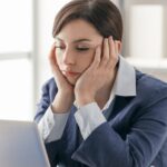 businesswomen unhappy at desk